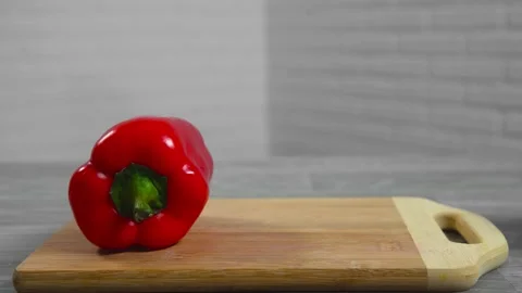 Pepper falls on a cutting board Stock Footage 194426723