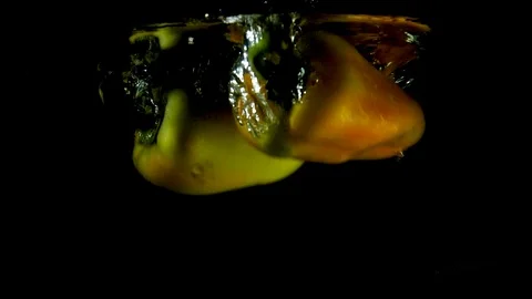Pepper falls in water on a black background with its mirror reflection Stock Footage 97059019