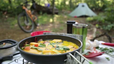 Pepper Grinder over Egg Scramble Breakfast on Camping Trip Stock Footage