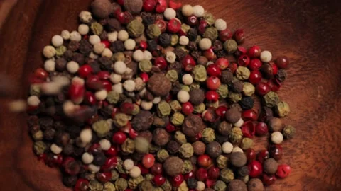 Pepper mix of red, black, white and allspice peppercorns pours Stock Footage 232603603