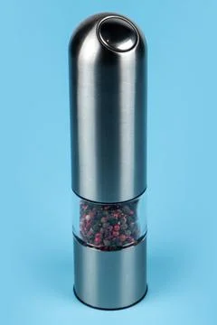 Pepper silver grinder on blue background Stock Photos