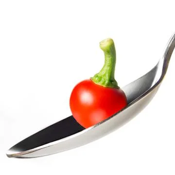 Pepper on spoon Stock Photos