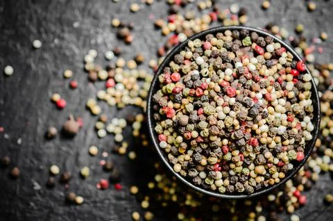 Peppercorn on rustic background. Stock Photos