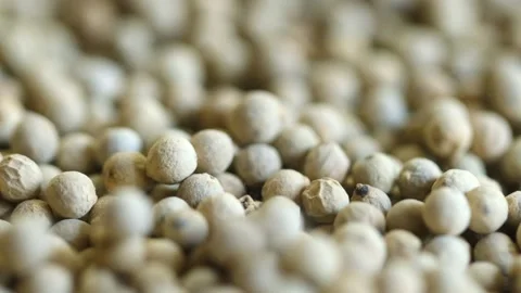 Peppercorns falling close up with rotation. Macro shot. Dried wite pepper grains Stock Footage 162469080