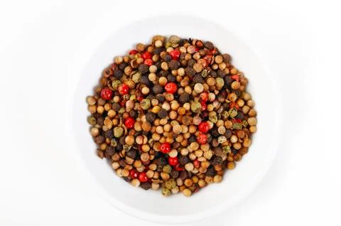 Peppercorns on white dish Stock Photos