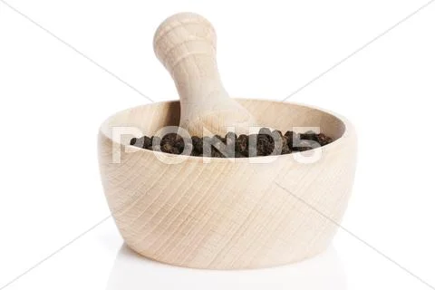 Peppercorns in a wooden mortar Stock Photos
