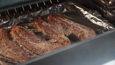 Peppered pork belly strips baking in the oven. Stock Footage 329637792
