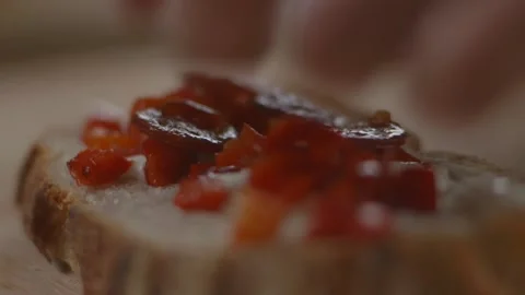 Pepperoni being placed onto tomatoes and slice of bread Stock Footage 194478457