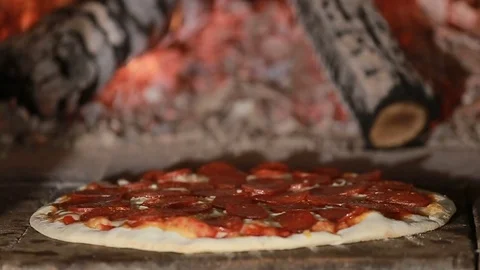 Pepperoni Pizza Baking in Wood Fired Oven Stock Footage 73254501