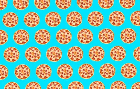 Pepperoni pizza pattern design on light blue background Stock Photos