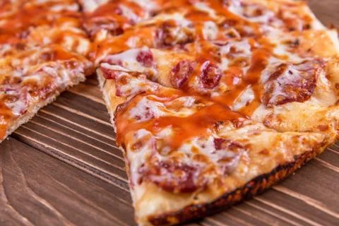 Pepperoni pizza on rustic background. Stock Photos