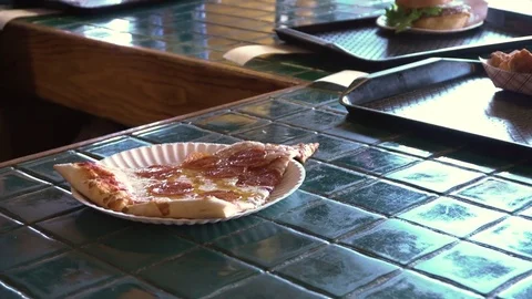 Pepperoni pizza slice being picked up from a counter Stock Footage 78107594