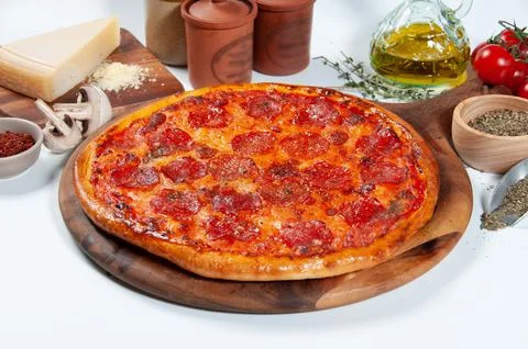 Pepperoni pizza with tomato, onion, chili powder, and black pepper isolated o Stock Photos