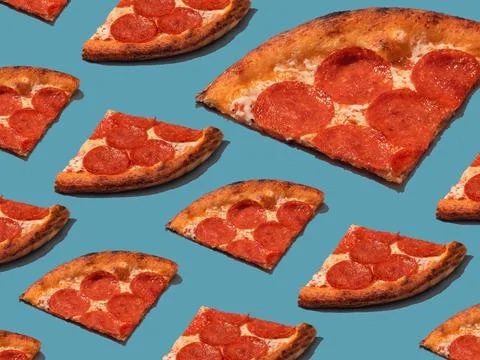 Pepperoni slice pizza pattern. Food pattern with hard shadows Stock Photos