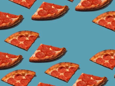 Pepperoni slice pizza pattern. Food pattern with hard shadows Stock Photos