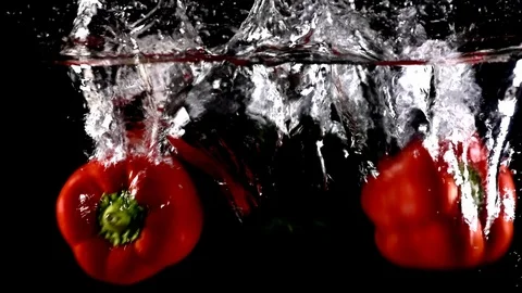 Peppers falling into water creating bubbles in aquarium in slow motion Stock Footage 126616027