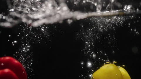 Peppers falling into water Stock Footage 254593383