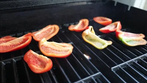 Peppers roasting on a gas grill Stock Footage 337831344