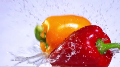 Peppers splashing in slow motion Stock Footage 56050112