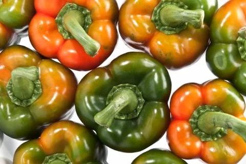 Peppers on a white surface. Stock Photos