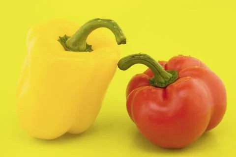 Peppers  on a yellow background Stock Photos