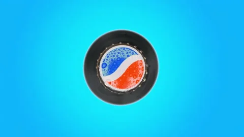 Pepsi cola bottle cap rotating on blue background top view Stock Footage