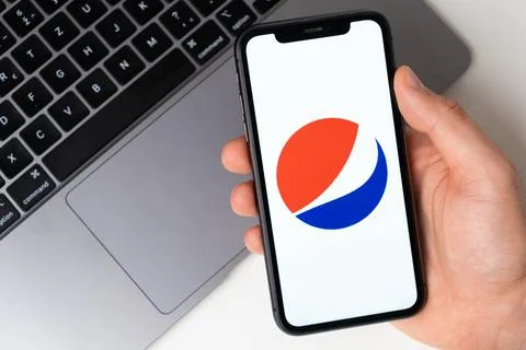 Pepsi mobile application on the smartphone screen. Make purchases while sitting Stock Photos