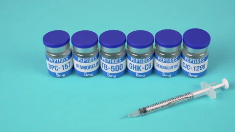 Peptide Vials and Insulin Syringe on Blue Background, Vertical Close Up Vídeos de archivo 342108250