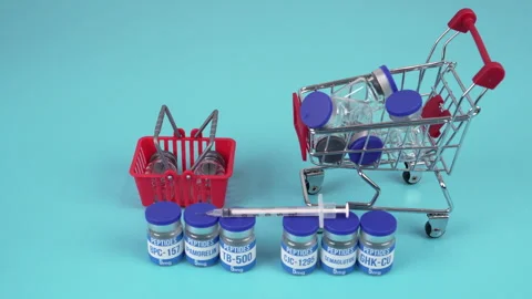 Peptide Vials with Syringe, Mini Shopping Cart and Basket on Blue Background Видео 344229731
