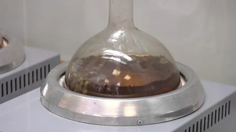 Percolator-boiler and reflux,distillation flask on heating element Stock Footage 100460764