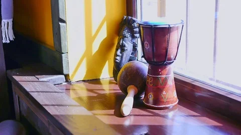 Percussion and mask standing on the window sill Stock Footage 85202328