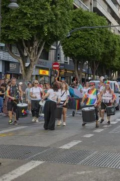 Percussion group performing music during pride parade procession downtown Stock Photos