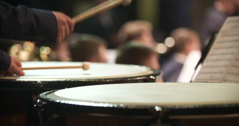Percussionist striking a concert drum during an orchestra performance Stock Footage 336472410