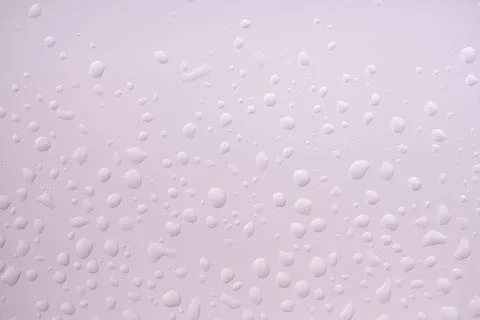Perfect backlit drops on light violet background Stock Photos