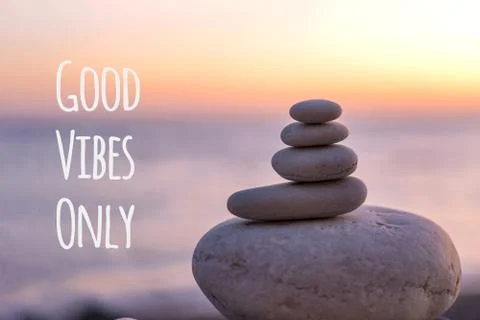 Perfect balance of stack of pebbles at seaside towards sunset. Concept of bal Stock Photos