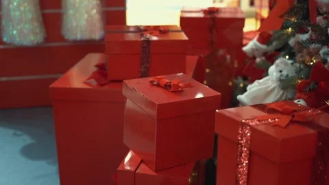 Perfect Christmas red gift boxes with red glitter ribbons and bows in toy store Video stock 220094600