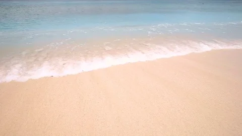 Perfect clean sand washed over by ocean wave Stock Footage 78528995