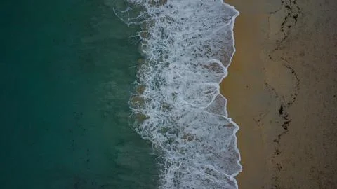 Perfect Contrast: Vertical Composition of Sandy Shoreline and Clear Surface Stock Photos