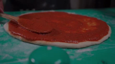 Perfect Cooking Distributing Red Sauce on Pizza Dough Stock Footage 293369327