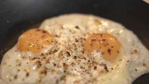 Perfect Fried Eggs with Crispy Edges and Runny Yolks Stock Footage 314405208