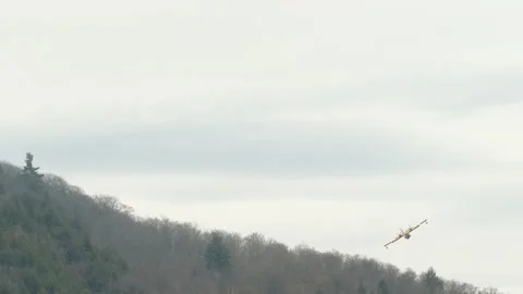 Perfect front facing shot of plane dropping water over smoky mountain Stock Footage 133971645