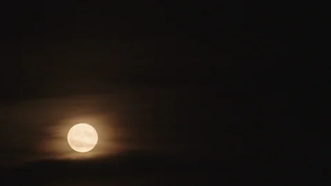 Perfect full moon shining through wispy clouds at night Stock Footage 129691591