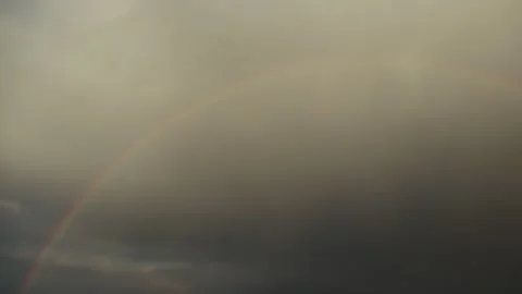 Perfect half rainbow with storm clouds as a background, rainy weather Stock Footage 265148054