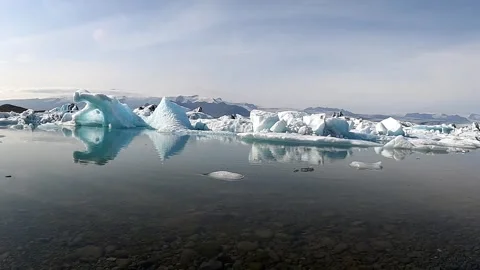 Perfect iceberg reflections in the calm waters of Jokulsarlon lagoon Stock Footage 333988631