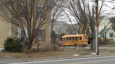 Perfect loop : Schoolbus driving in typical suburbs on a rainy day Stock Footage 109608193
