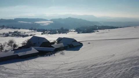 Perfect outro — flight over a farm, in front of which children sled in the snow, Видео 334634252