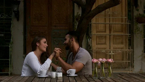 Perfect partners holding hands while on a date at coffee cafe. Stock Footage 199632970