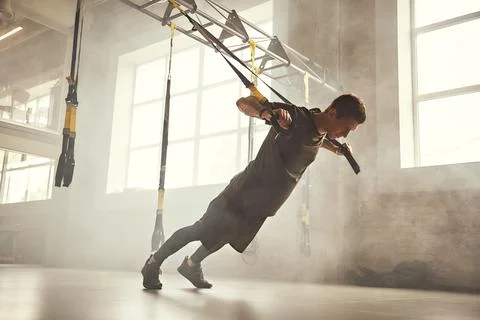Perfect push-up. Side view of young and strong athletic man in sportswear doing Stock Photos