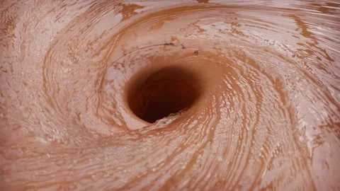 Perfect, rapidly rotating water helix descending into storm drain opening Stockbeeldmateriaal 339039133