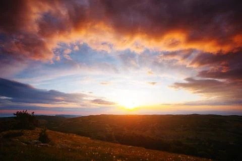 Perfect red clouds illuminated by the beams of the sun. Stock Photos